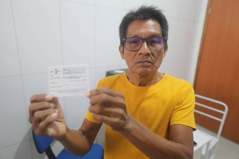 Raimundo da Silva exibe sua caderneta de vacina tomada.